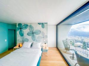 a bedroom with a bed and a large window at The Window in Bellinzona