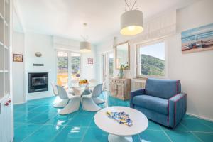 a living room with a blue tile floor and a table and chairs at Relais Miramar in Termini