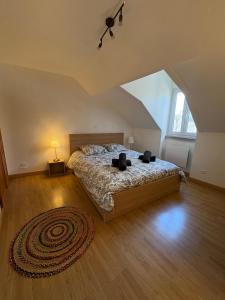 a bedroom with a large bed in a attic at Le Petit Ussellois in Ussel