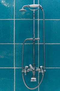 a shower in a blue tiled wall at Relais Miramar in Termini +48 photos