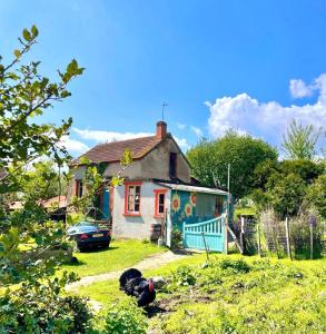 a house with a painting on the side of it at petite maison artistique in Saint-Plantaire