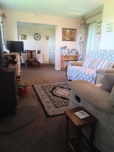 a living room with a couch and a table at West Point B&B in Bude