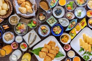 a table with plates of food and bowls of food at Kochi Sunrise Hotel in Kochi