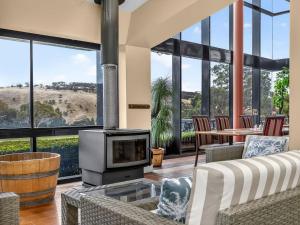a living room with a couch and a fireplace at BreakFree Wirrina Cove in Wirrina Cove