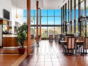 a restaurant with tables and chairs and large windows at BreakFree Wirrina Cove in Wirrina Cove +53 photos