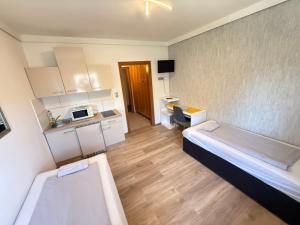 a small room with two beds and a kitchen at Pension Günther self Check-in free parking in Graz