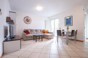 a living room with a couch and a table at Castel View Apartment - Gardaslowemotion in Tenno +35 photos