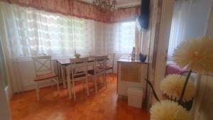 a dining room with a table and chairs and a window at Apartment MrC , FREE PARKING in Bežanija