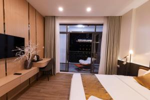 a hotel room with a bed and a television at HomeAi Apartment - Binh Thanh near Landmark 81 in Ho Chi Minh City