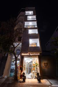 a building with a sign on the front of it at HomeAi Apartment - Binh Thanh near Landmark 81 in Ho Chi Minh City +15 photos