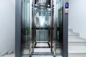 an elevator in a building with a clock on the wall at HomeAi Apartment - Binh Thanh near Landmark 81 in Ho Chi Minh City
