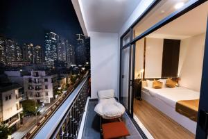 a bedroom with a balcony with a view of a city at HomeAi Apartment - Binh Thanh near Landmark 81 in Ho Chi Minh City