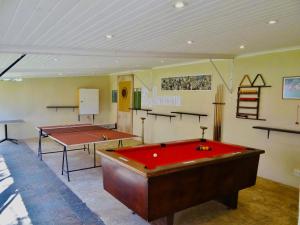 a room with a pool table and two ping pong tables at Jimmy's Place in Dinokeng Game Reserve