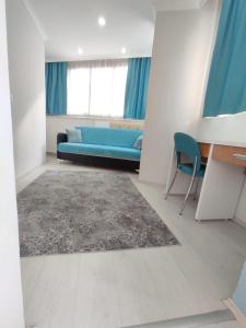 a living room with a blue couch and a chair at Can Residence in Trabzon +11 photos
