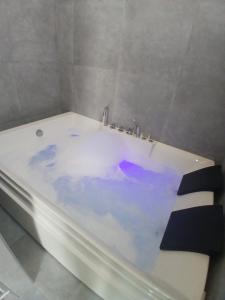 a white bath tub sitting in a bathroom at Tursi Relais Virtus in Tursi