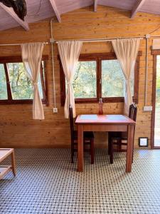 a room with a table and chairs in a cabin at Can Cospito in Osor