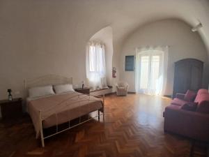 a living room with a bed and a couch at Tursi Relais Virtus in Tursi