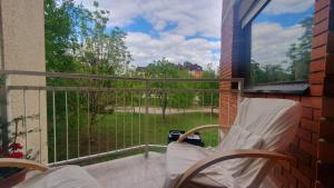 a balcony with two chairs and a large window at Apartment MrC , FREE PARKING in Bežanija