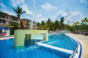 a pool with a fountain in a resort at Brookside Valley Resort in Rayong