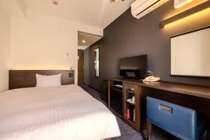 a hotel room with a bed and a flat screen tv at Kochi Sunrise Hotel in Kochi +20 photos