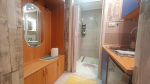 a bathroom with a sink and a shower with a mirror at Apartment MrC , FREE PARKING in Bežanija +28 photos