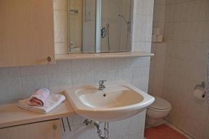 a bathroom with a sink and a toilet at Mattheishof in Grafenau +34 photos