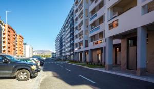 a car parked on a street next to a building at Podgorica Royal Apartment in Podgorica