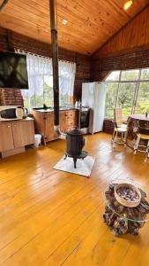 a kitchen with a stove in the middle of a room at Studio Rústico - Refúgio Arara Azul in Urubici