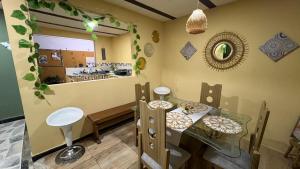 a dining room with a table and a counter at Hospedaje in Salento