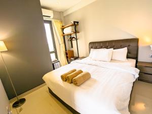 a bedroom with a bed with two towels on it at Lovina 5-AA at One Residence in Batam Center