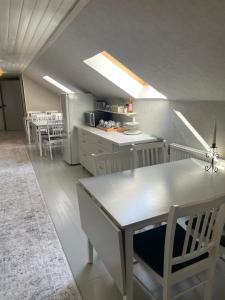 a kitchen with a table and some chairs in a room at Huset på hörnet in Hammenhög +17 photos