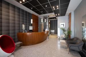 a lobby with a reception desk and chairs at Hotel Longoria Plaza by Pandora Hoteles in Oviedo