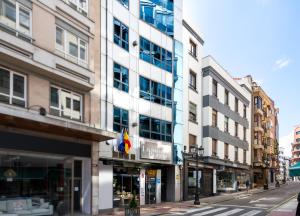 a building on a city street with buildings at Hotel Longoria Plaza by Pandora Hoteles in Oviedo