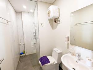 a bathroom with a toilet and a sink and a shower at Lovina 5-AA at One Residence in Batam Center +9 photos