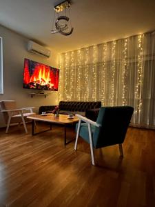 a living room with a table and a fireplace at Apartmani SEEBLICK in Konjic