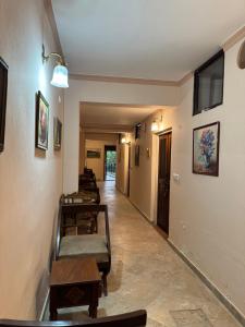 a hallway with a row of chairs and tables at Navya Niwas - The Rooms in Dehradun