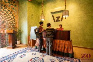a group of people standing at a counter in a room at Zo Selections Jaipur by Zostel in Jaipur