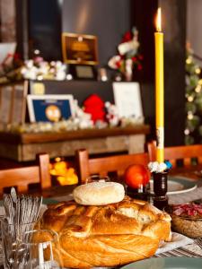a table with a loaf of bread and a candle at Dvorac Castelo DB 2022 in Vrnjačka Banja