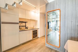 a kitchen with white cabinets and a mirror at Yangji Yeju in Zhuhai +173 photos
