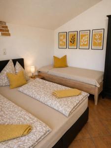 a room with two beds with yellow pillows on them at Gästezimmer Lercher in Sankt Veit im Pongau