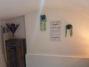 a room with plants on the wall and a sign on the wall at Zum Feriennest in Ochtendung