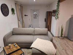 a living room with a couch and a table at Zum Feriennest in Ochtendung