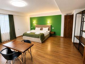 a hotel room with a bed and a table at BB Old City in Tbilisi City
