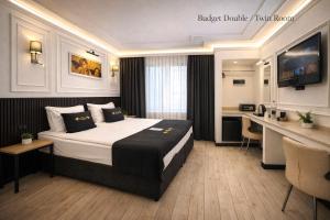 a hotel room with a bed and a desk at Angel's Home Suites - Angel Group Hotels in Istanbul +77 photos