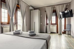 a bedroom with a bed with towels on it at Malù House in Fiumicino