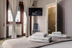 a bedroom with a bed with towels on it at Malù House in Fiumicino