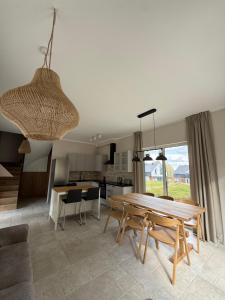 a kitchen and dining room with a table and chairs at Aura Kaszub Lake&Forest in Łączyno