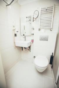 a white bathroom with a toilet and a sink at Just Inn Hotel in Istanbul +35 photos