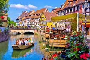 a group of people riding in a boat on a river at New ! VUE PETITE VENISE-PLACE TO BE - PARKING in Colmar