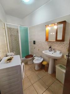 a bathroom with a sink and a toilet and a sink at Casa dell'orso in Rocca di Botte